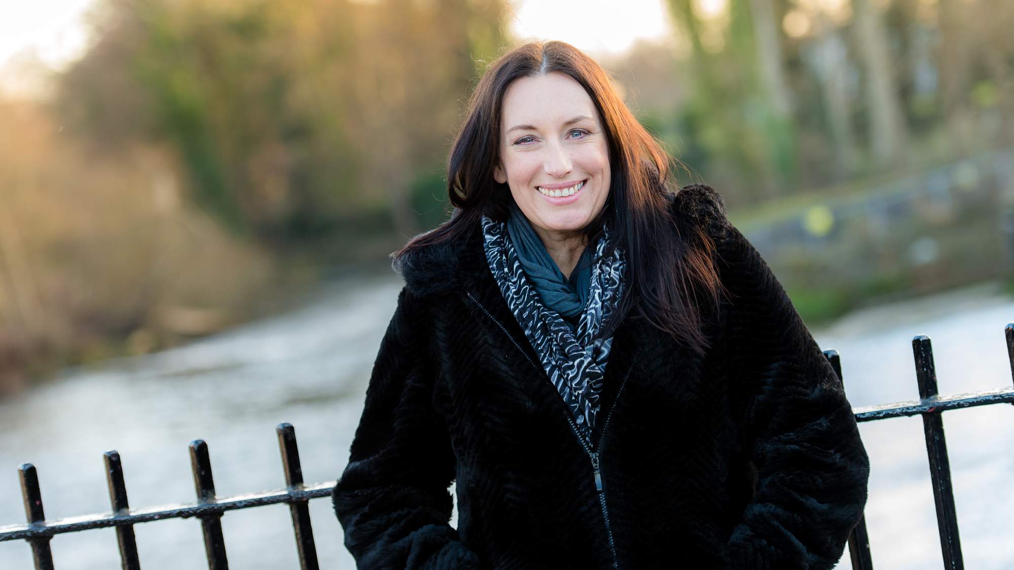 female business owner, portrait outside by river