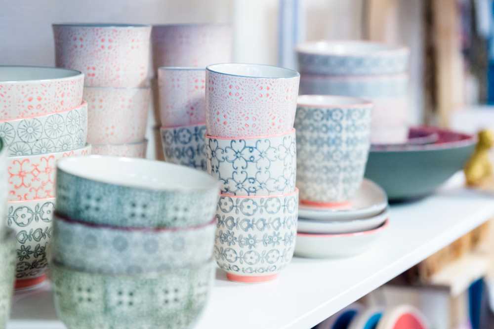 decorated ceramic bowls and cups, green and peachy pink detail