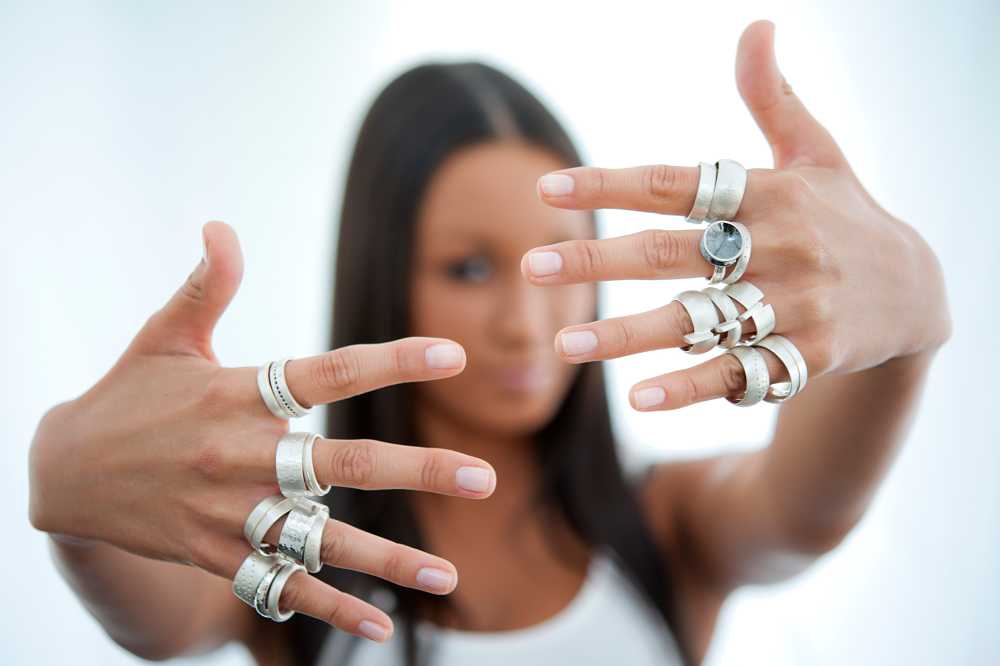 silver jewellery, rings designed by TLK.com model hands in front of face