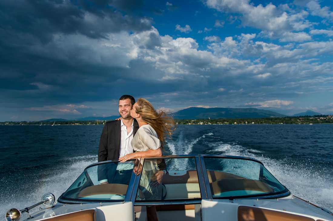 couple on speedboat on lake geneva with very dark storm clouds behind