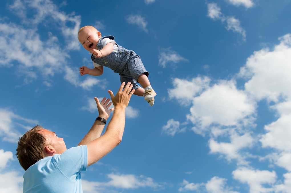 father and baby playing at airplanes, blue sky