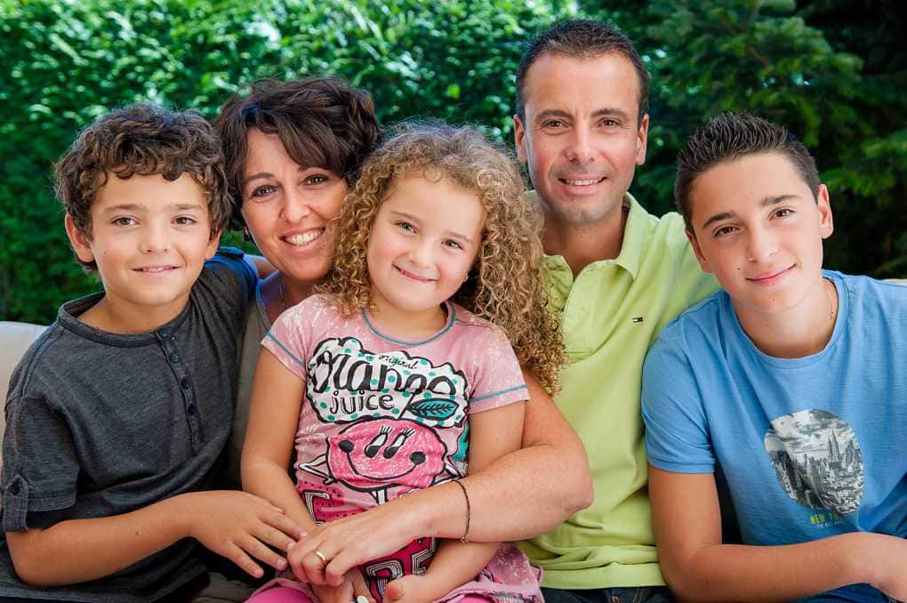 family of five cuddled up facing camera