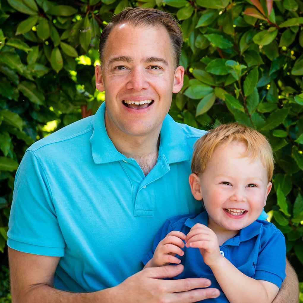 father and son in blue shirts sitting together