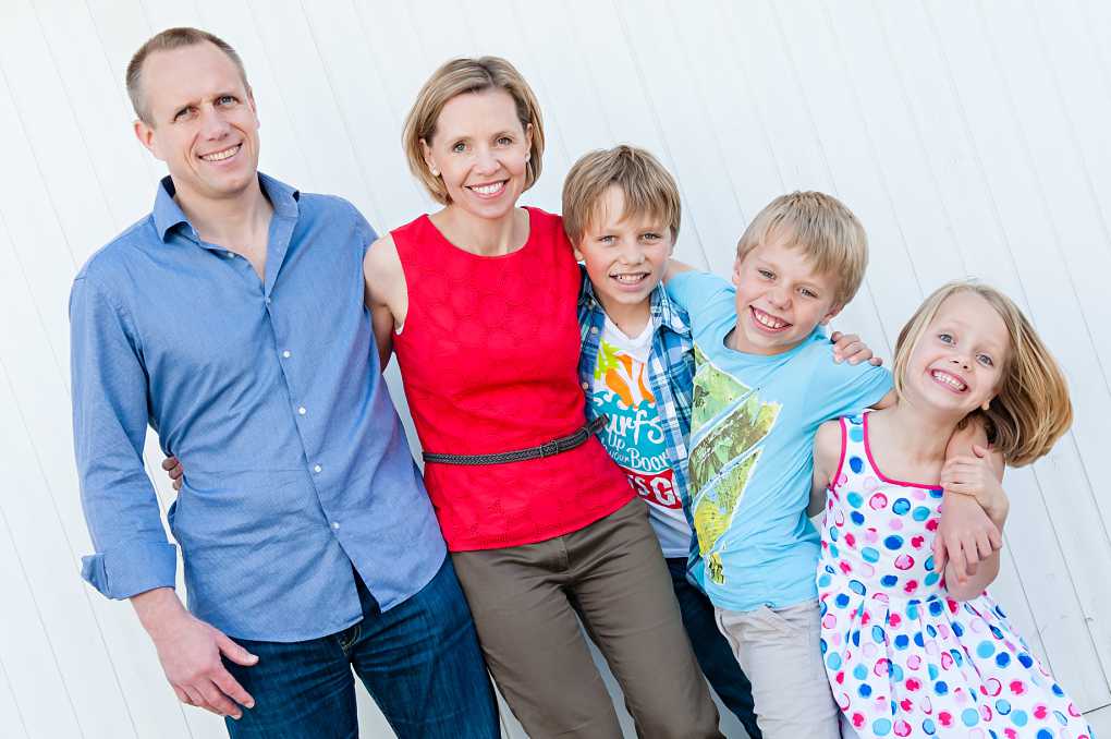 family of five arms around each other facing the camera