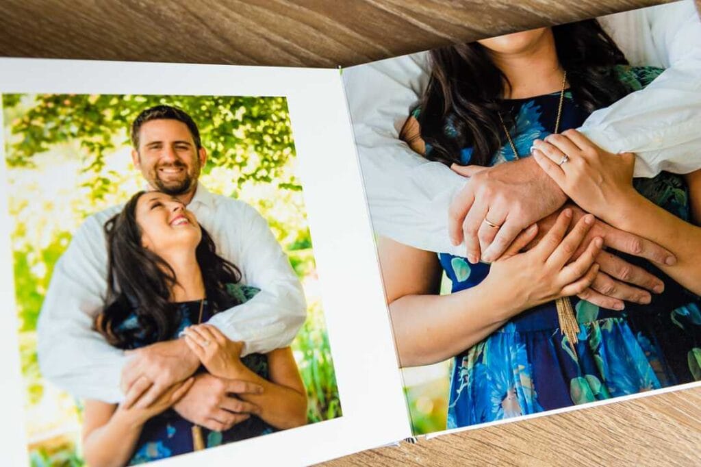 couple laughing in small photo album